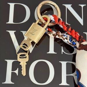 Authentic Louis Vuitton padlock with keys and unbranded keychain/bagcharm.